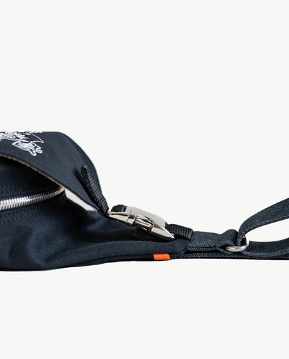 An aluminum side-squeeze buckle secures the front flap of Dock 5’s spacious, hand-sewn Lake Superior Canvas Sling Bag