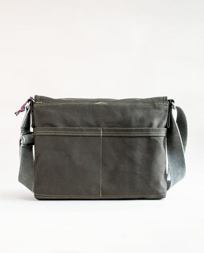Back exterior pockets of Dock 5’s Snowy Owl Canvas Messenger Bag in olive featuring art from owner Natalija Walbridge