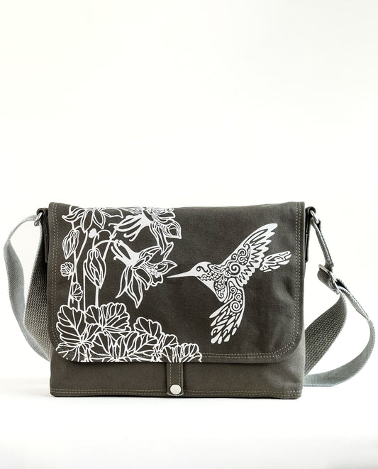 Front exterior of Dock 5’s Hummingbird Canvas Messenger Bag in olive featuring art from owner Natalija Walbridge