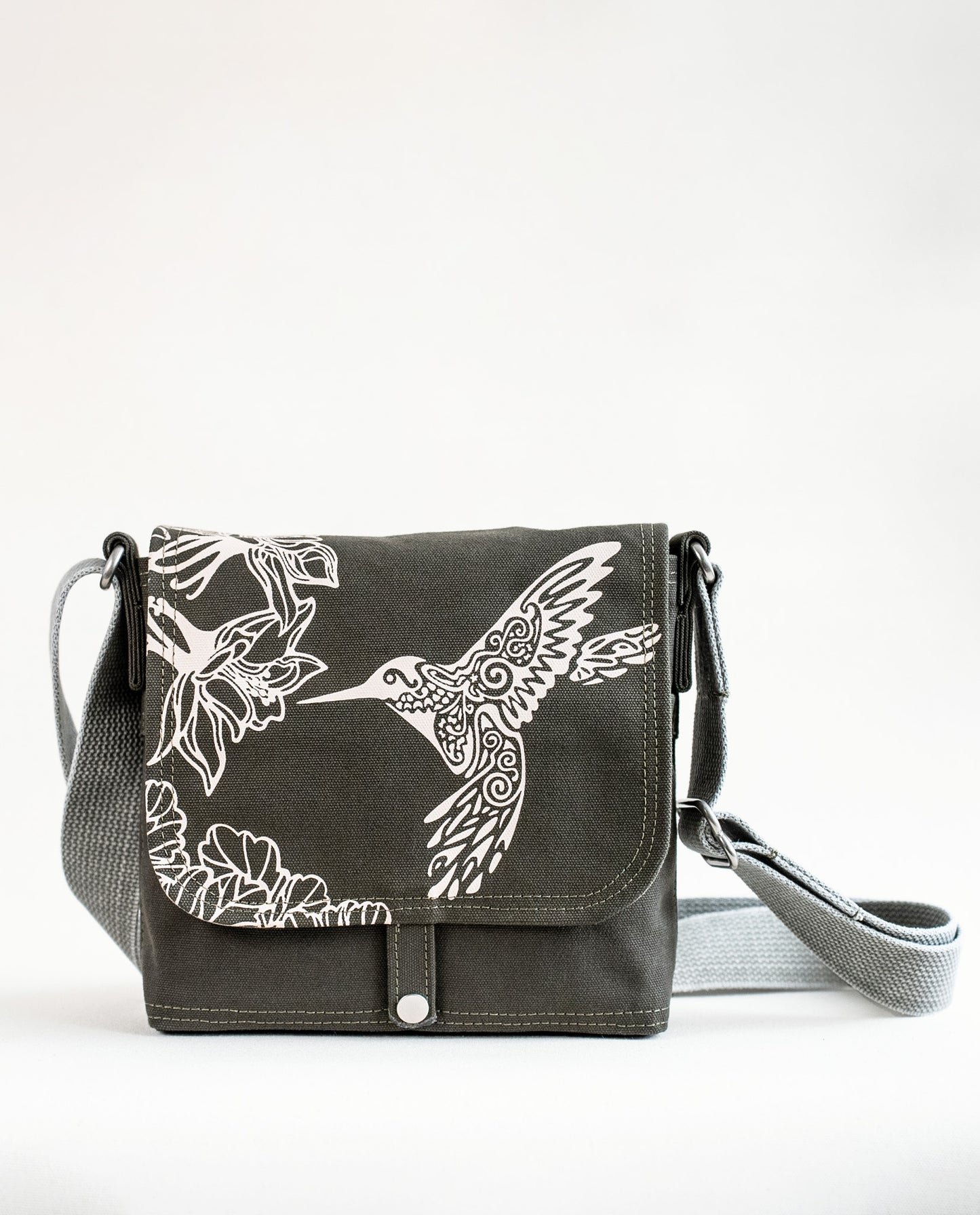Front exterior of Dock 5’s Hummingbird Canvas Mini Messenger Bag in olive featuring art from owner Natalija Walbridge