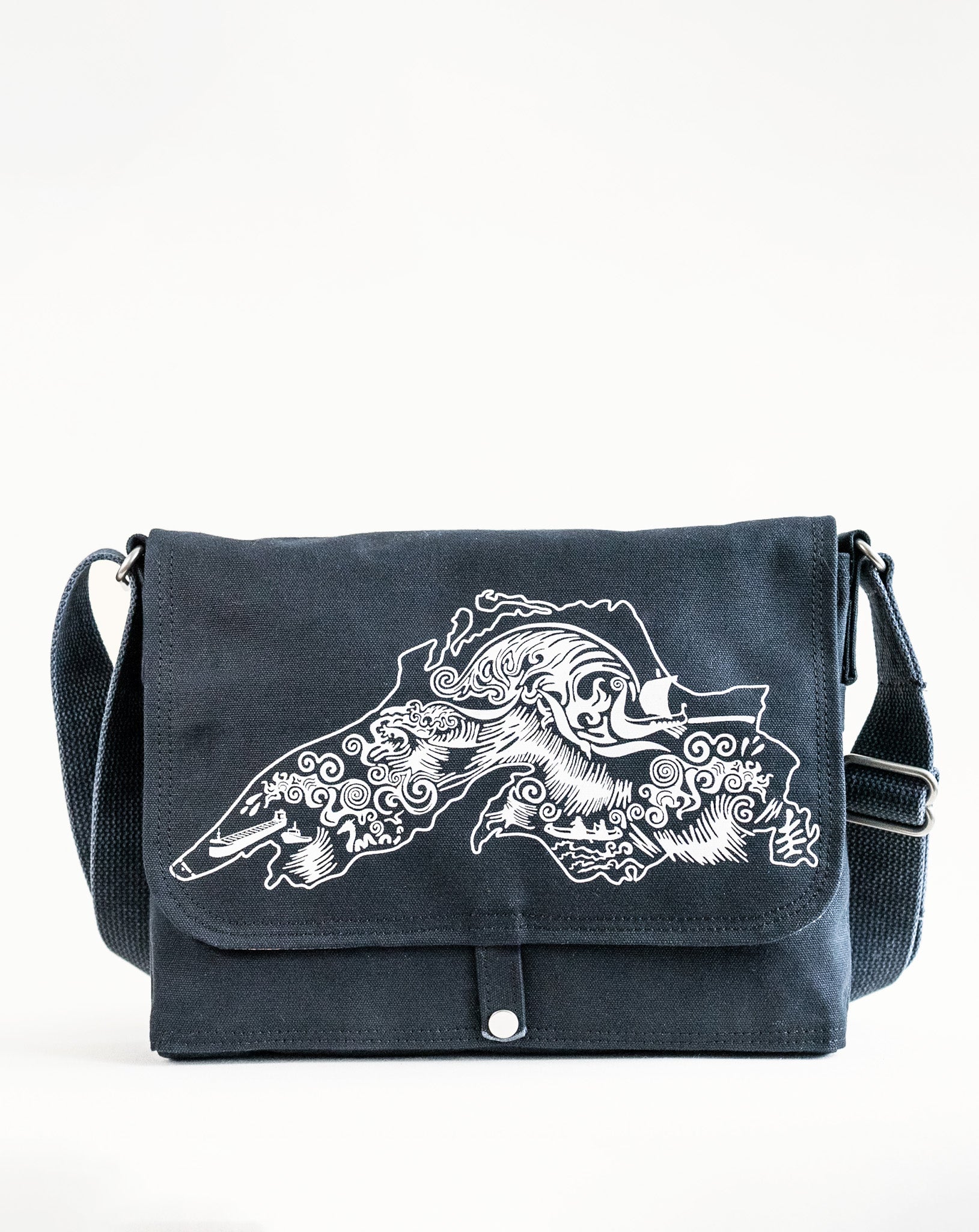 Front exterior of Dock 5’s Lake Superior Canvas Messenger Bag in black featuring art from owner Natalija Walbridge