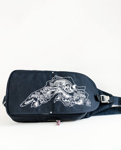 Front exterior of Dock 5’s Lake Superior Canvas Sling Bag in black featuring art from owner Natalija Walbridge