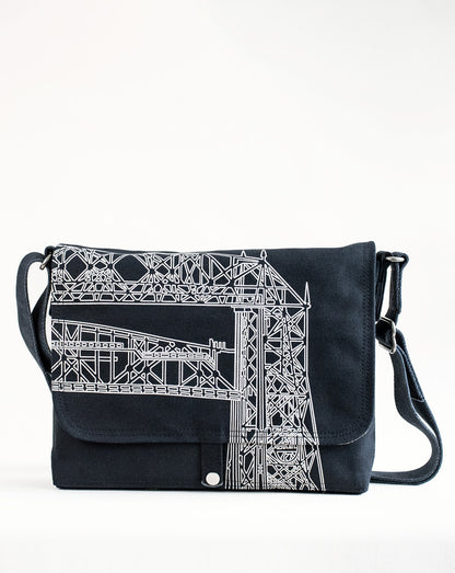 Front exterior of Dock 5’s Lift Bridge Canvas Messenger Bag in black featuring art from owner Natalija Walbridge