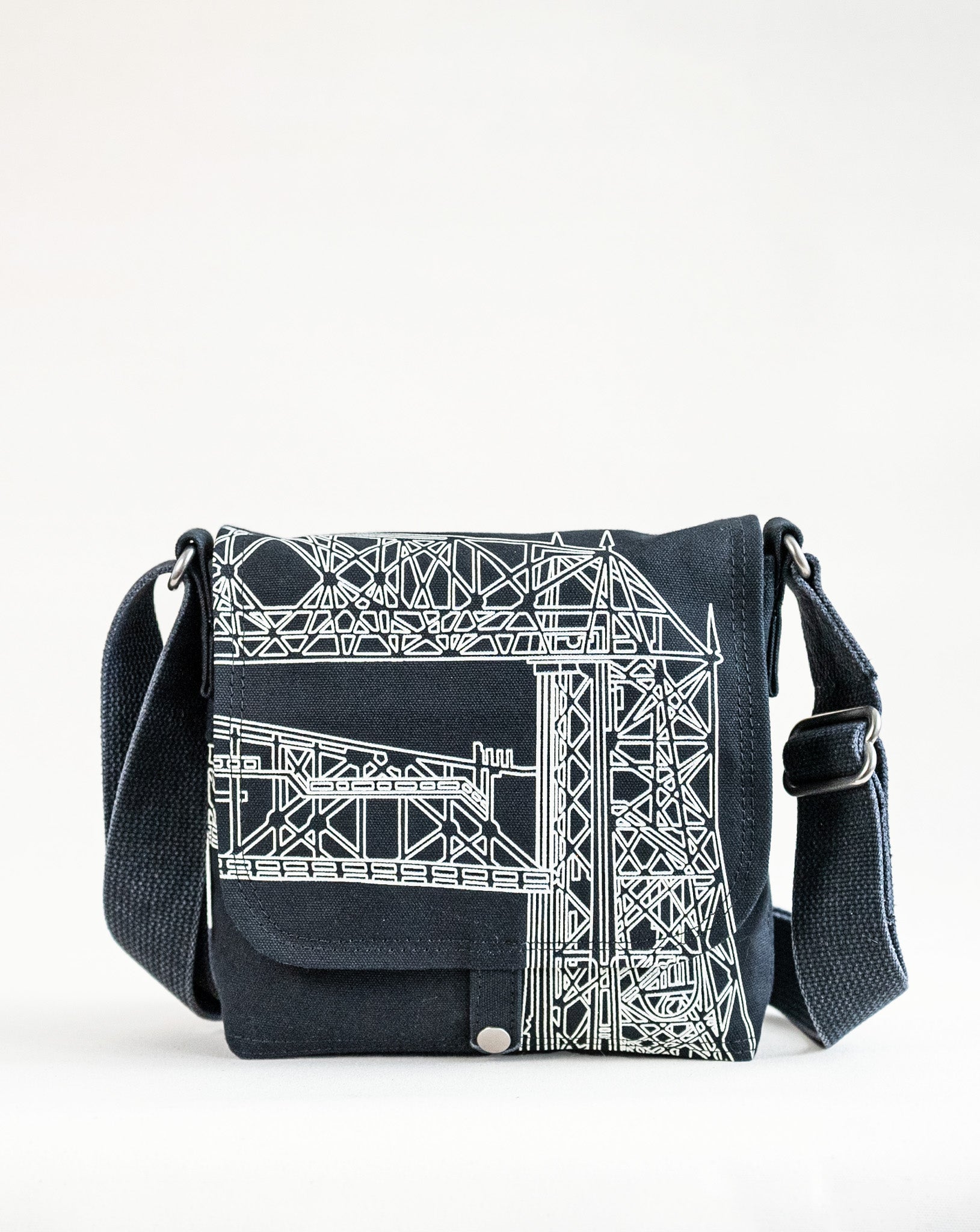 Front exterior of Dock 5’s Lift Bridge Canvas Mini Messenger Bag in black featuring art from owner Natalija Walbridge