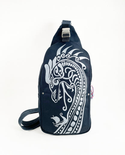 Front exterior of Dock 5’s Viking Dragon Canvas Sling Bag in black featuring art from owner Natalija Walbridge