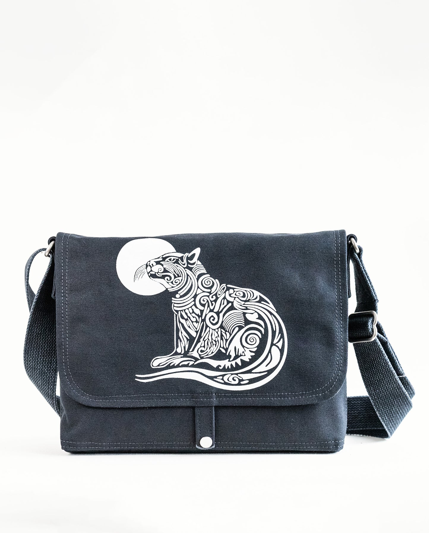 Front exterior of Dock 5’s Wild Cat Canvas Messenger Bag in black featuring art from owner Natalija Walbridge