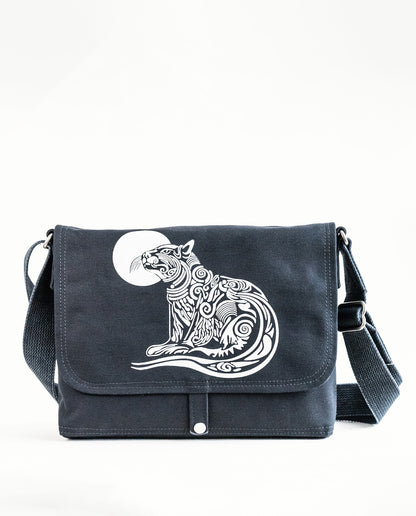 Front exterior of Dock 5’s Wild Cat Canvas Messenger Bag in black featuring art from owner Natalija Walbridge