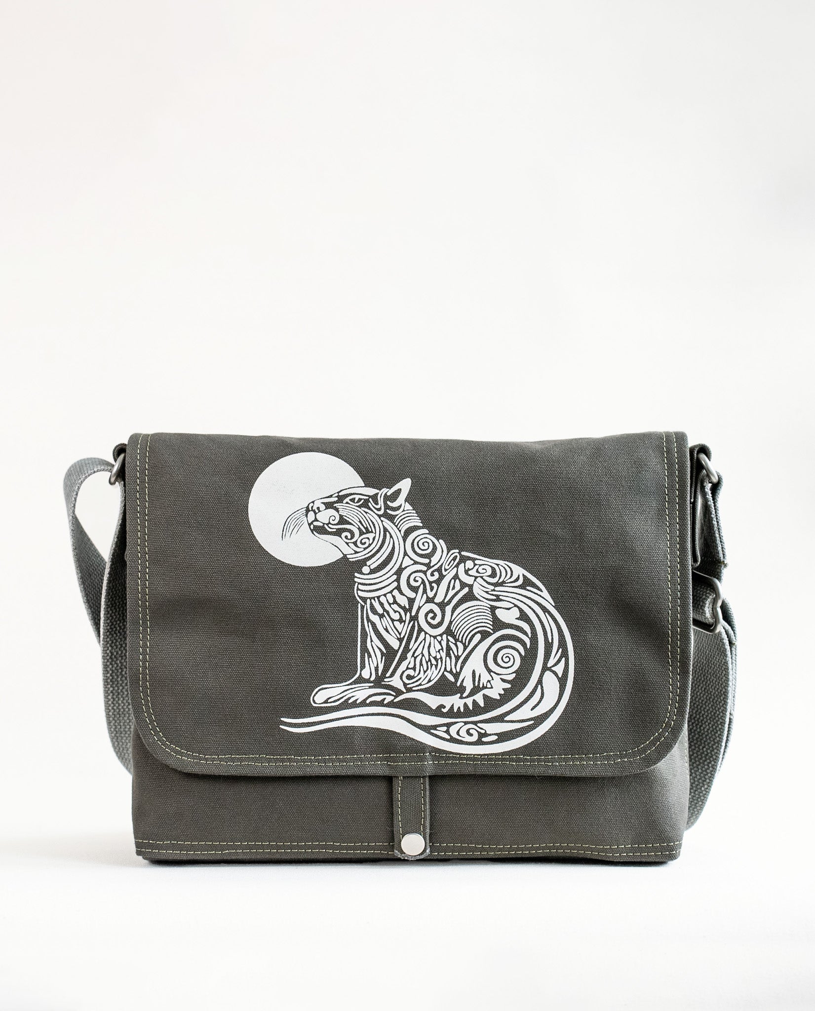 Front exterior of Dock 5’s Wild Cat Canvas Messenger Bag in olive featuring art from owner Natalija Walbridge