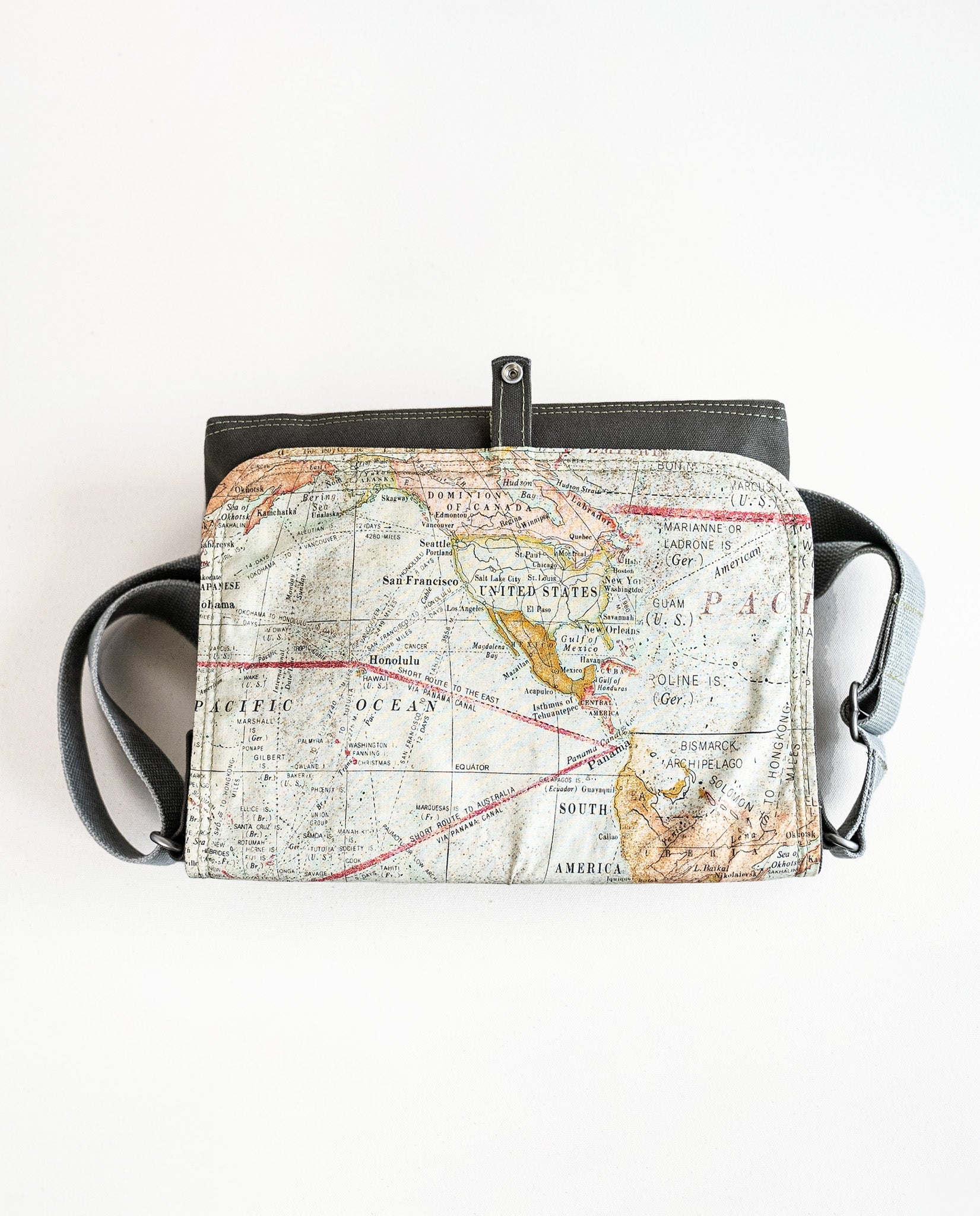 Inside of flap showing vintage map print lining fabric of Dock 5’s Lift Bridge Canvas Messenger Bag in olive featuring art from owner Natalija Walbridge