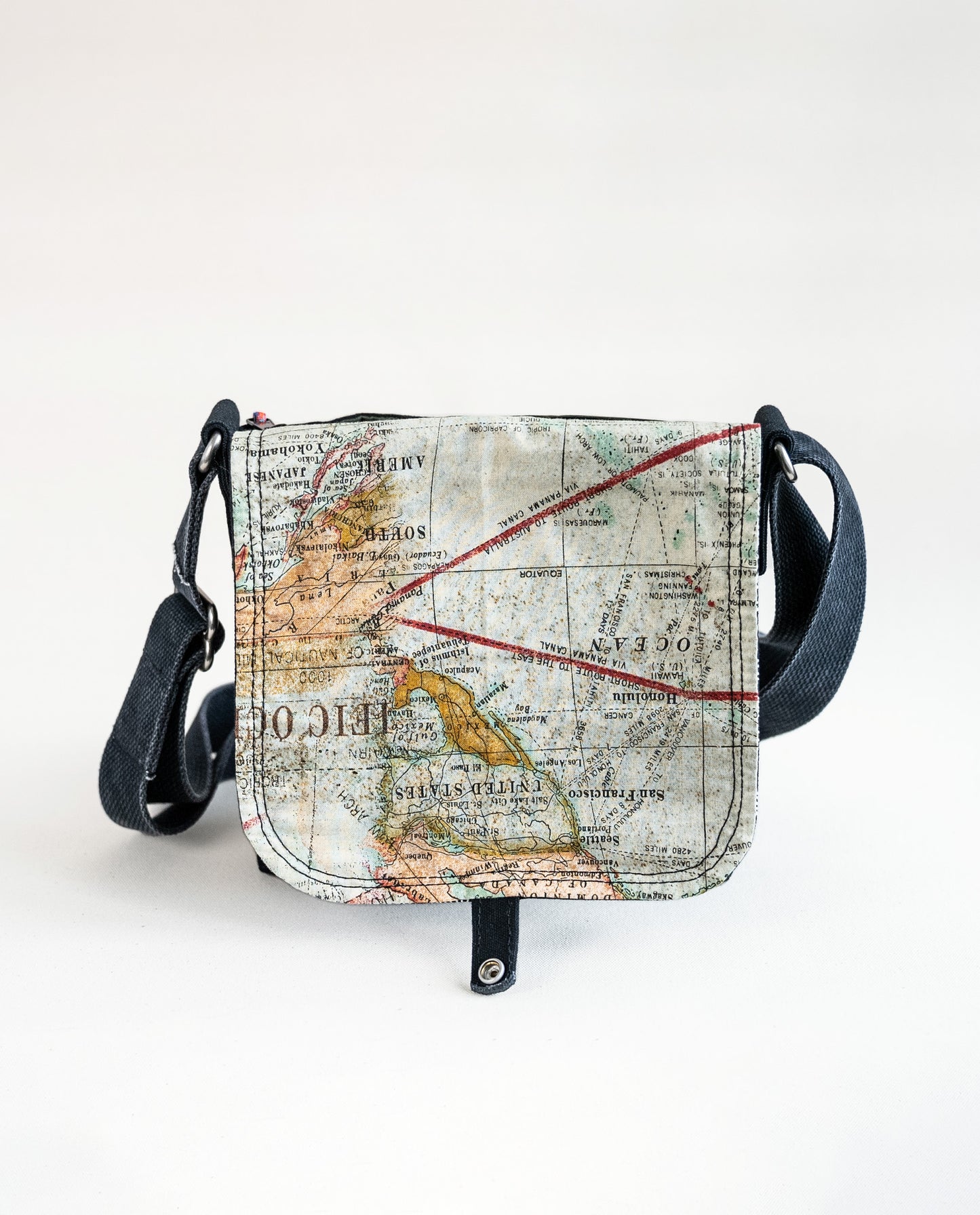 Inside of flap showing vintage map print lining fabric of Dock 5’s Lift Bridge Canvas Mini Messenger Bag in black featuring art from owner Natalija Walbridge