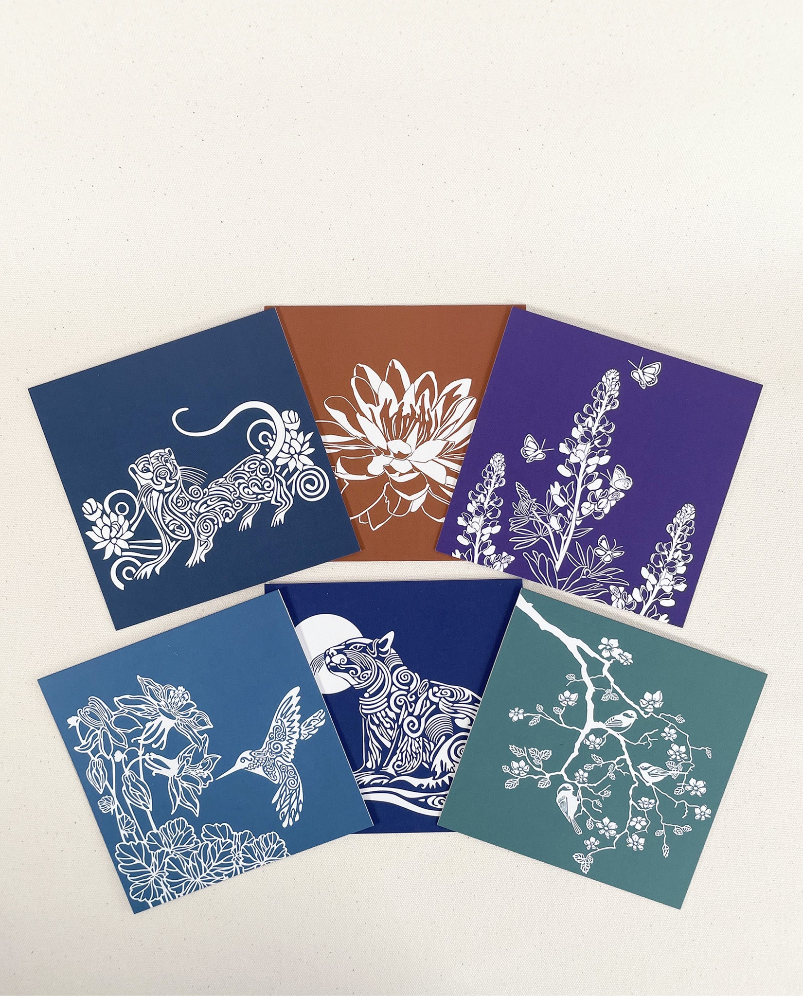 Set of six note cards with nature art, including a River Otter, Hummingbird, Lupine, Lotus, Cat, and Chickadees, by Natalija Walbridge Dock 5