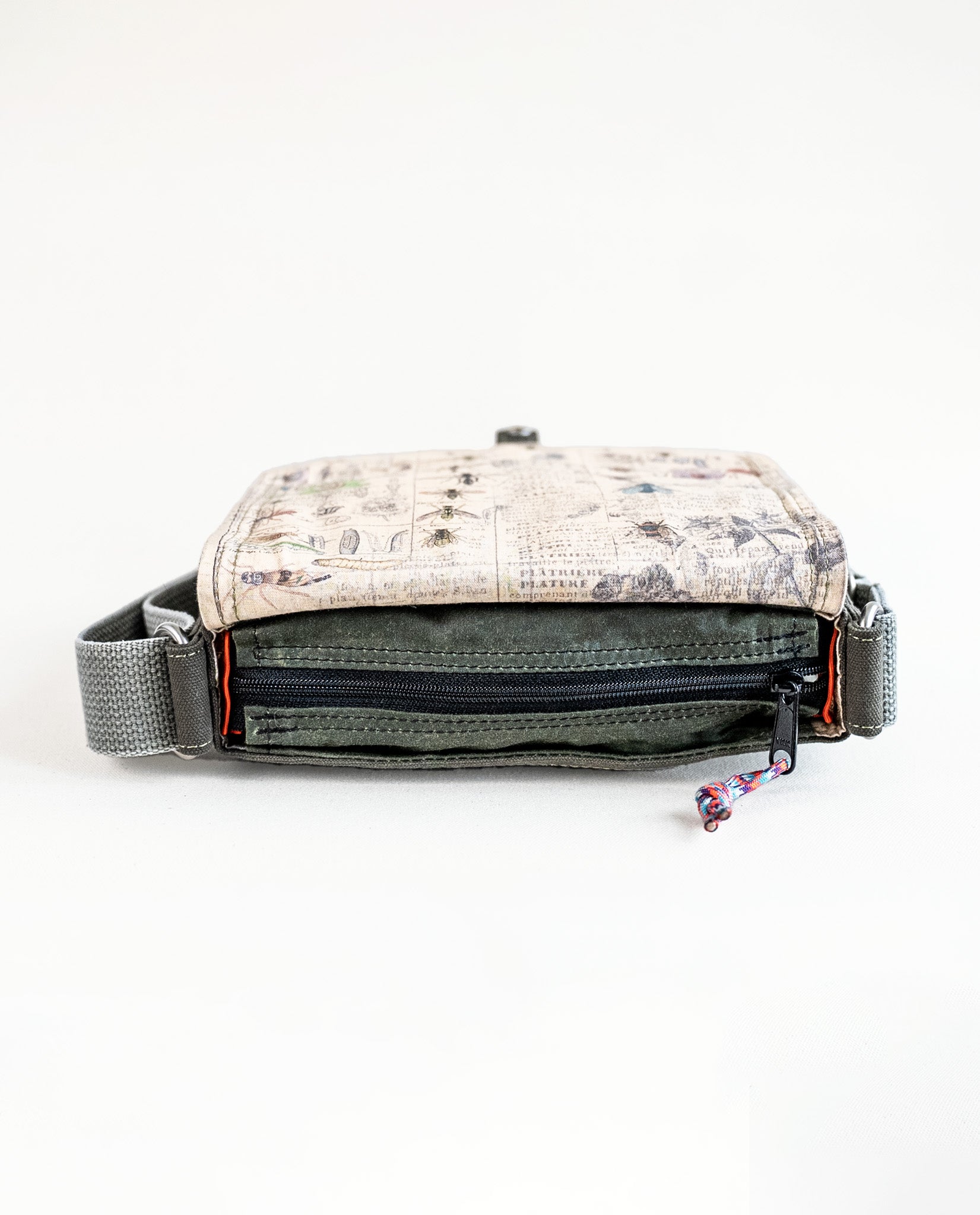 Top view of zipper opening of Dock 5’s Hummingbird Canvas Mini Messenger Bag in olive featuring art from owner Natalija Walbridge